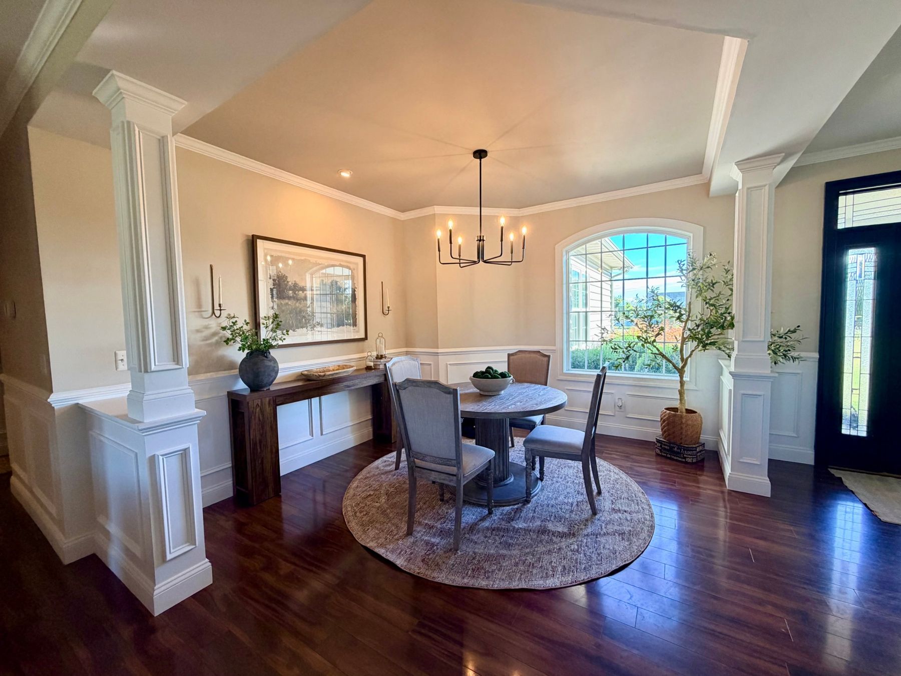 Dining room with paneled columns, wainscoting and crown molding